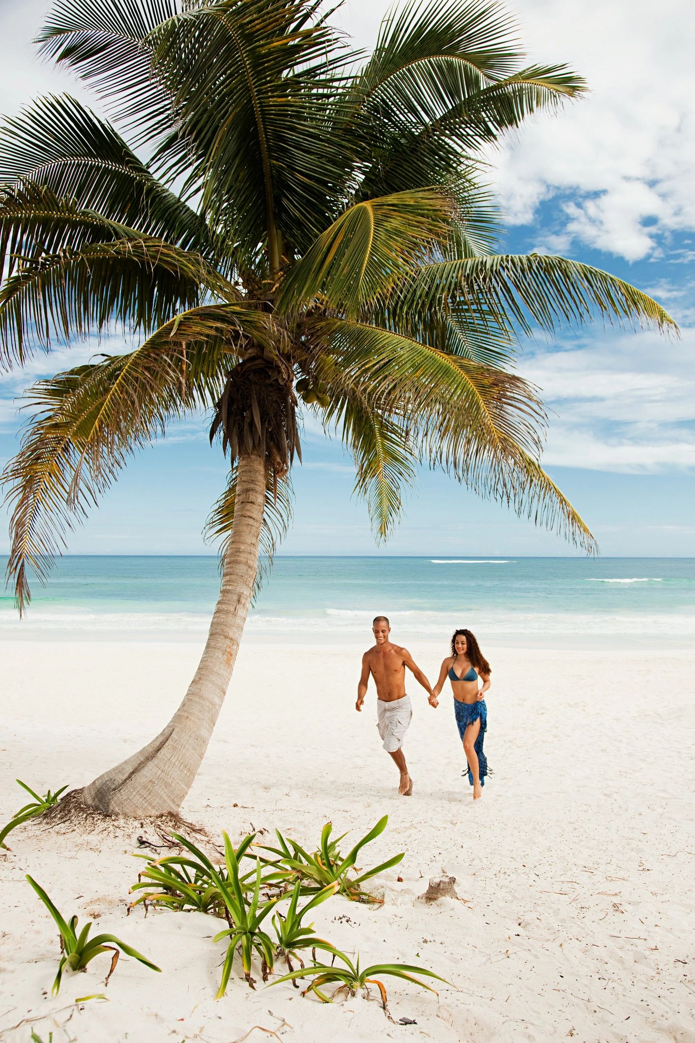 Couple walking on sandy beach