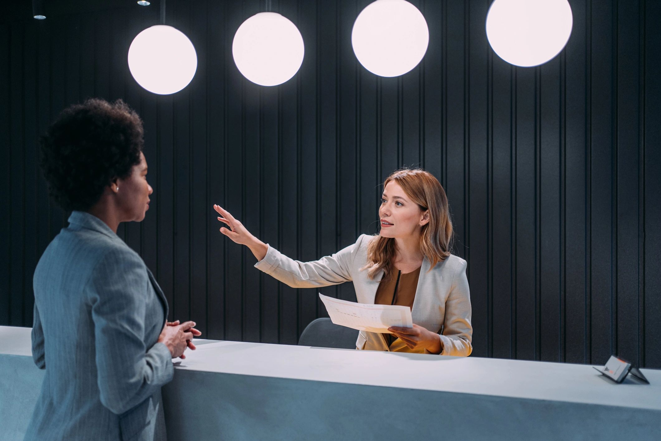 Hotel receptionist assisting a guest at the front desk